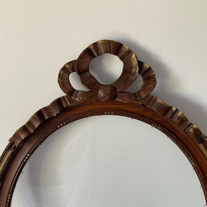 French vintage very large frame in wood, with ribbon and knot, 1900 Handmade, with oval glass, 25.78 inches
