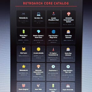May include: A dark image displaying the RetroArch Core Catalog. The catalog features various gaming platforms, including Nintendo DS, MS-DOS/PC, Arcade, and Nintendo Entertainment System. Each platform is represented by a small icon and text.