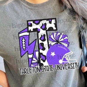 May include: Gray t-shirt featuring a purple and white graphic design. The design includes a football, a lightning bolt, pom-poms, and a football helmet. The text "TARLETON STATE UNIVERSITY" is printed below the graphic.