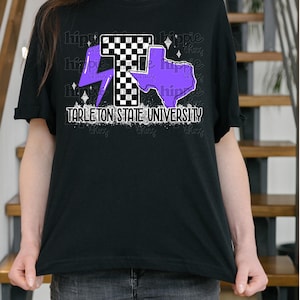May include: Black t-shirt featuring a graphic design with a checkered "T", a purple lightning bolt, and a purple outline of Texas. The text "Tarleton State University" is printed below the graphic. The word "hippie" is repeated in a pattern.