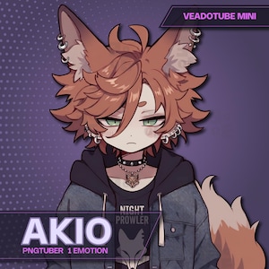 A premium premade fox boy PNGTuber model named AKIO for Veadotube Mini. A cute, sleepy anime boy with messy ginger hair, large fox ears with multiple silver hoop piercings, and green eyes. He is wearing a dark denim jacket over a black hoodie and a Night Prowler graphic t-shirt.