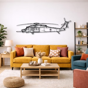 May include: A black metal wall art piece depicting a helicopter silhouette. The artwork is mounted on a white wall above a yellow sofa. The helicopter design includes detailed outlines of the fuselage, rotors, and tail.