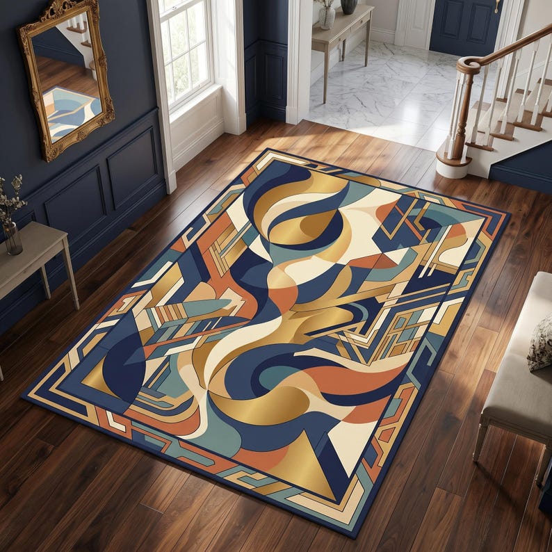 May include: A rectangular area rug with an abstract geometric design. The rug features a border and a central pattern in shades of navy blue, gold, beige, and orange. The rug is placed on a hardwood floor.