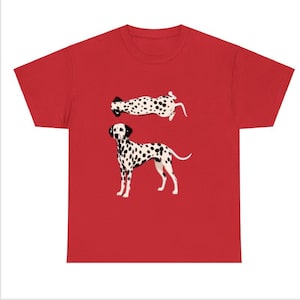 May include: Red t-shirt featuring two Dalmatian dog illustrations. One dog is standing, the other is lying down. Both dogs have black spots on a white background. The shirt is made of a soft material.