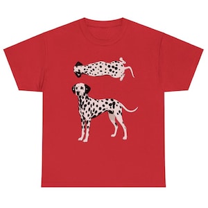 May include: A red short-sleeved t-shirt featuring a graphic print of a Dalmatian dog. The design includes one Dalmatian standing in profile and a second Dalmatian shown from a top-down perspective, both displaying the breed's signature black spots.