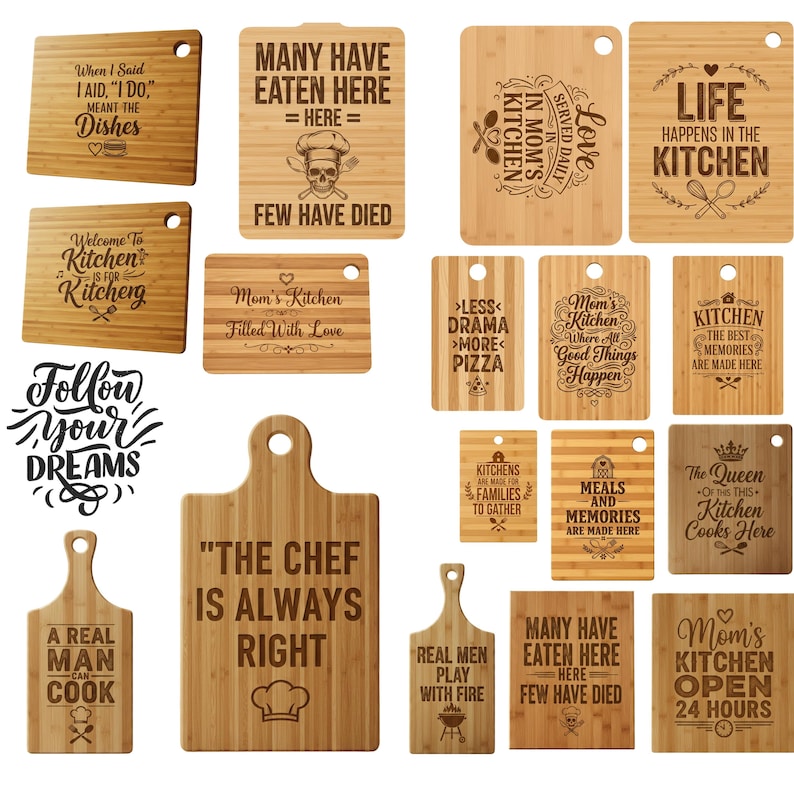 May include: A collection of bamboo cutting boards with various engraved kitchen-themed phrases and designs. Some boards feature text like "The Chef Is Always Right" and "Life Happens in the Kitchen." Other boards have humorous sayings.