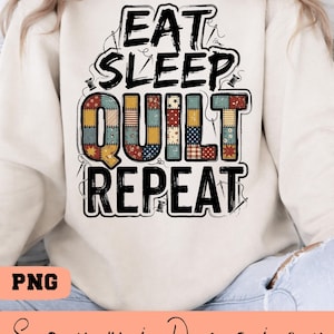 May include: Cream-colored sweatshirt with the text "EAT SLEEP QUILT REPEAT" in a black, stitched font. The word "QUILT" is filled with a patchwork design in various colors. The image also includes the text "PNG" and the name "Soumi Design".
