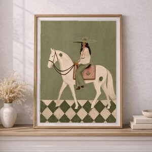 May include: A framed wall art print featuring a person wearing a wide-brimmed hat, a white blouse, and green trousers, riding a white horse. The horse has green circular markings and a pink saddle blanket. The background is green with a checkered floor.