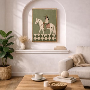 May include: A framed rectangular wall art print featuring a painting of a person wearing a wide-brimmed hat and green trousers riding a white horse. The horse stands on a green and white checkered floor against a solid sage green background.
