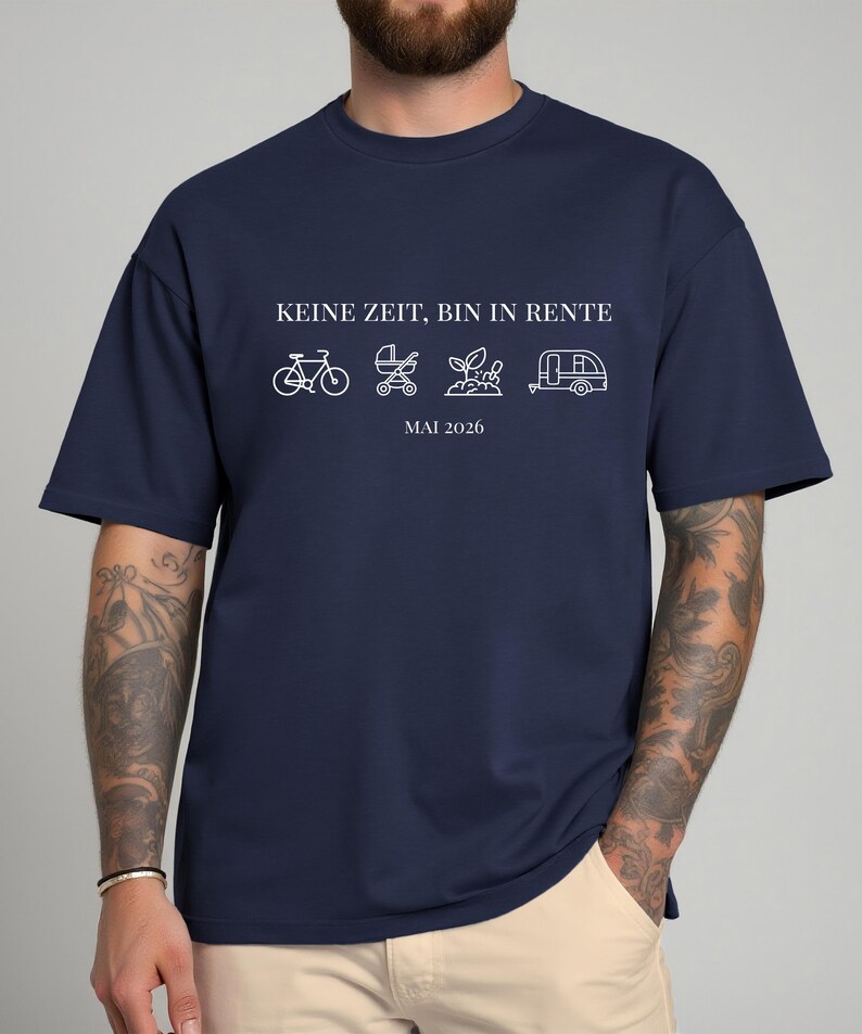 May include: Navy blue t-shirt with white text and line art illustrations. The text reads "KEINE ZEIT, BIN IN RENTE" above a bicycle, stroller, plant, and camper. Below the illustrations is "MAI 2026".