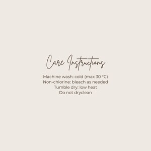 May include: A beige background with the words "Care Instructions" in a cursive font. Below, care instructions are listed: machine wash cold (max 30 &deg;C), non-chlorine bleach as needed, tumble dry low heat, and do not dry clean.