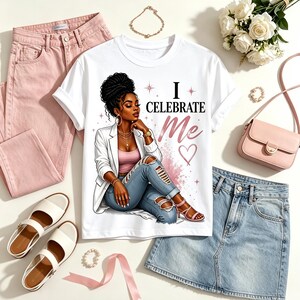 May include: A white t-shirt featuring a graphic illustration of a person with dark hair in a high bun, wearing a white blazer, pink top, and distressed blue jeans. The text "I CELEBRATE Me" is printed in black and pink with small star and heart accents.