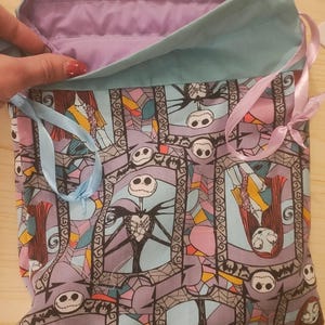 May include: A white ceramic mug with a black handle and the text "But First, Coffee" in a black, bold font. The mug is on a white surface.