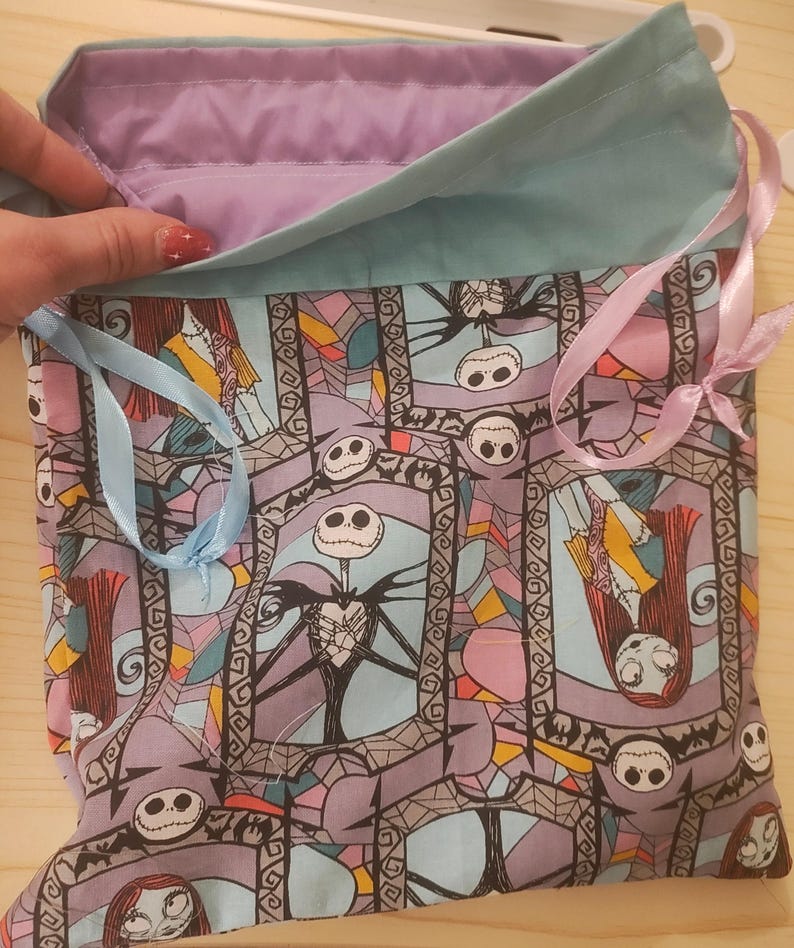 May include: A white ceramic mug with a black handle and the text "But First, Coffee" in a black, bold font. The mug is on a white surface.