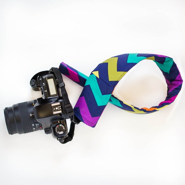 DSLR camera strap cover with lens cap pocket.  multi colored chevron.