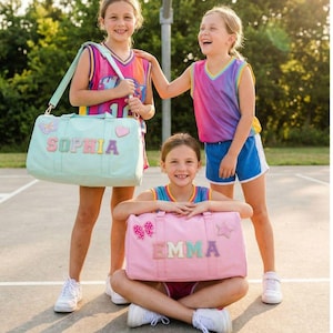 May include: A set of three ceramic mugs with a speckled, matte finish. The mugs are in shades of cream, light gray, and dark gray. Each mug has a simple, minimalist design and a rounded handle.