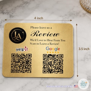 May include: A rectangular gold-colored sign measuring 4 inches by 3.5 inches. It features a black circular logo with the letters LA, the text Please leave us a Review, We'd Love to Hear From You, Scan to Leave a Review, and two QR codes.