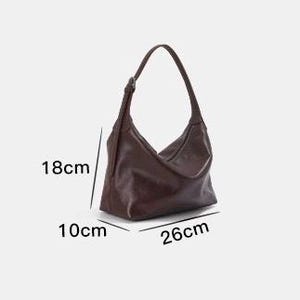 May include: A brown shoulder bag with a single strap. The bag is 10.2 inches long, 7.1 inches high, and 3.9 inches wide. The bag has a simple, minimalist design.