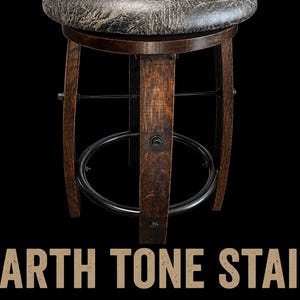 May include: A round bar stool with a dark, textured, weathered-look seat and a base constructed from curved, dark-stained wooden staves. The structure includes a black metal circular footrest and horizontal support bars. Text reads: EARTH TONE STAIN.