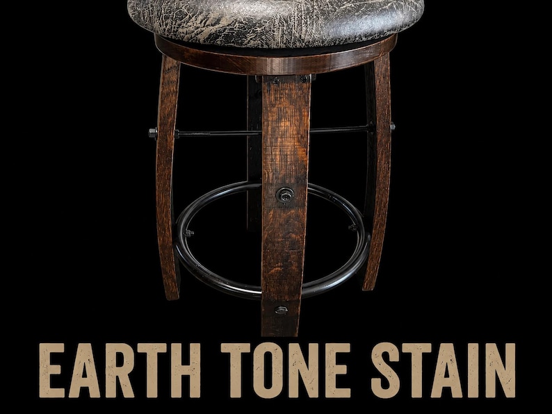 May include: A round bar stool with a dark, textured, weathered-look seat and a base constructed from curved, dark-stained wooden staves. The structure includes a black metal circular footrest and horizontal support bars. Text reads: EARTH TONE STAIN.