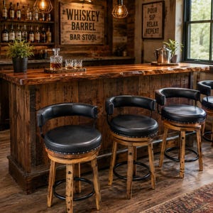 May include: Four swivel bar stools with black circular padded seats and curved backrests, featuring wooden legs and a black metal foot ring. The stools are positioned in front of a long, rustic wooden bar counter with a natural live edge finish.
