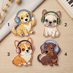 May include: Four embroidered patches featuring cartoon dogs wearing headphones. Patch 1 is a golden puppy with blue headphones, 2 is a cream French bulldog with green headphones, 3 is a tan corgi with pink headphones, and 4 is a brown dachshund with blue headphones.