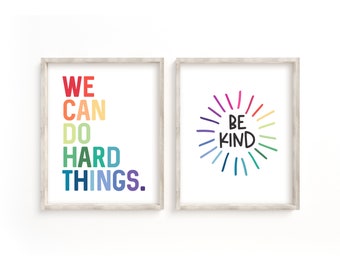 May include: Two framed prints with rainbow-colored text. The first print says "We can do hard things." The second print has a rainbow sunburst with the text "Be Kind" in the center.