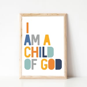 May include: A framed print with the text "I AM A CHILD OF GOD" in colorful block letters. The letters are in shades of blue, yellow, orange, and gray.