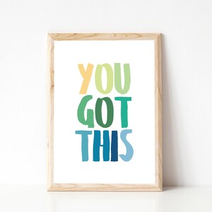 May include: A framed print with the text "YOU GOT THIS" in a rainbow of colors, from yellow to blue.