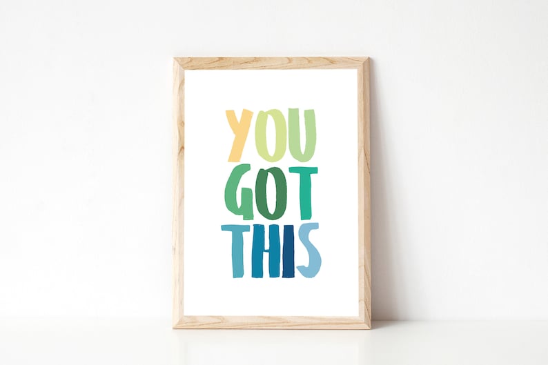 May include: A framed print with the text "YOU GOT THIS" in a rainbow of colors, from yellow to blue.