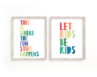 May include: Two framed prints with colorful text. The first print says "This is where the fun stuff happens". The second print says "Let kids be kids".