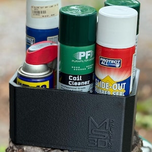 May include: A black, textured container holding several aerosol cans of various sizes and colors. The cans include products like coil cleaner, rubber seal, and dry lubricant. The container has the text "M3D PRINTING" on the side.