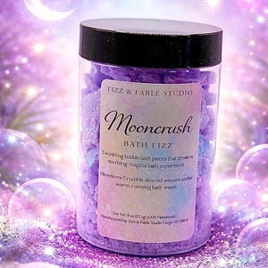 May include: A clear plastic jar with a black lid filled with purple bath fizz. The label reads "Mooncrush Bath Fizz" and includes instructions. The background is a dreamy purple with a crescent moon and sparkling stars.