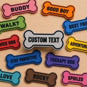May include: A collection of colorful dog bone-shaped tags with various phrases and words. The tags are in shades of pink, orange, green, red, blue, yellow, purple, brown, and teal. The central tag reads "CUSTOM TEXT".