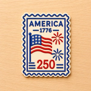 May include: A cream-colored stamp-shaped magnet with a blue border and scalloped edges. The design features the word "AMERICA" above "1776" and "250". A red, white, and blue American flag and fireworks are also included.