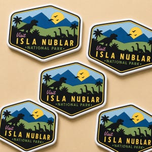 May include: A collection of hexagonal stickers with a black border. Each sticker features a landscape with a dinosaur, palm trees, mountains, and a sun. The text reads "Visit Isla Nublar National Park."