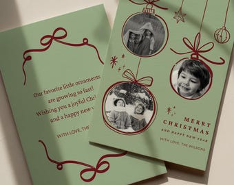 May include: Two sage green holiday cards featuring red line-art illustrations of hanging ornaments and bows. The cards include circular photo frames containing black and white images of children, with text reading Merry Christmas and Happy New Year.