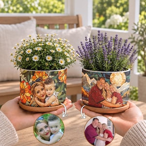 May include: Two cylindrical ceramic planters with wooden saucers, each featuring a custom mosaic-style photo print. One planter displays a woman and child with orange flowers, the other shows a family of three with a mountain landscape and moon.