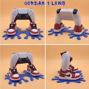 May include: A white and black video game controller stand featuring miniature red, white, and black sneakers as feet, mounted on a blue splash-shaped base. The text JORDAN 1 LOWS is displayed at the top of the four-panel image composition.