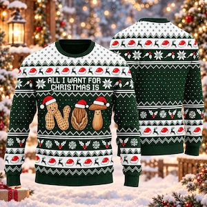 May include: A dark green long-sleeve sweater featuring a white knit pattern of reindeer, Santa hats, and holly. The front displays the text "ALL I WANT FOR CHRISTMAS IS" above a graphic of a peanut, an almond, and a mushroom wearing Santa hats.