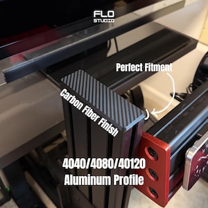 May include: Black aluminum profile with a carbon fiber finish, labeled "4040/4080/40120 Aluminum Profile." The product is part of the FLO STUDIO line and is designed for a perfect fitment.