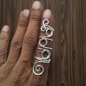 May include: A handmade wooden sign with the text "Welcome" in a handwritten style. The sign is painted white with a distressed finish and features a small, decorative heart. It is designed for indoor or outdoor use.