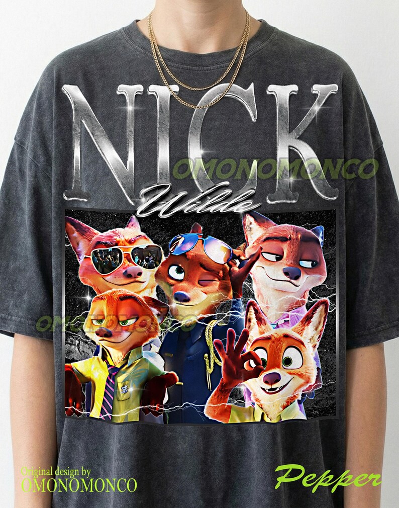 May include: Dark gray t-shirt featuring a graphic of Nick Wilde from Zootopia. The design includes the name "NICK Wilde" in silver lettering and images of Nick Wilde in various poses. The shirt has a crew neck and short sleeves.