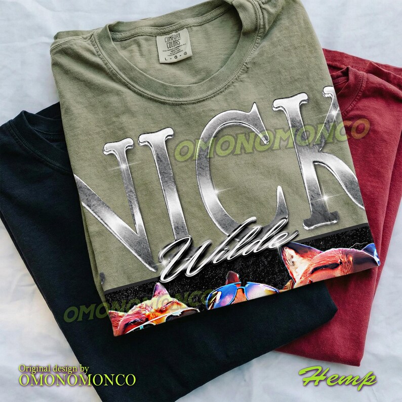 May include: Three t-shirts in black, olive green, and maroon. The olive green shirt features the name "NICK Wilde" in a shiny, silver font, with a graphic of animal faces at the bottom. The text "OMONOMONCO" and "Hemp" are also visible.