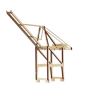 May include: A wooden model of a crane with a brown base and a light brown boom. The crane is made of multiple pieces of wood that are connected together.
