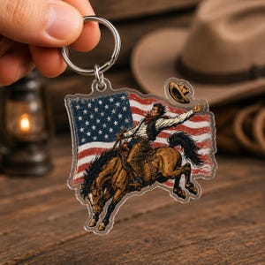 Western acrylic keychain mockup featuring cowboy riding bucking horse with distressed American flag PNG design