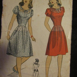 May include: Vintage sewing pattern for a dress with a gingham bodice and a skirt with a floral print. The pattern is for size 12 with a bust measurement of 30 inches. The pattern is from the "Du Barry Perfect Pattern" line.