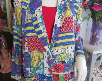 May include: A colorful, patterned blazer with a white background. The pattern features flowers, musical instruments, and geometric shapes in shades of red, blue, yellow, green, and purple.