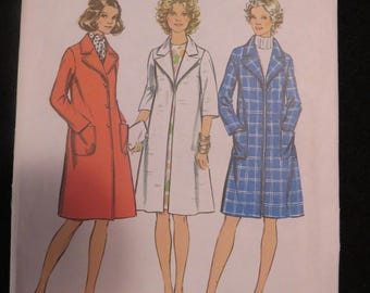 May include: Vintage Simplicity sewing pattern 5526. The pattern features three women's coat designs. The pattern is size 12, with a 34-inch bust. The pattern is marked with the text "Look Slimmer pattern".