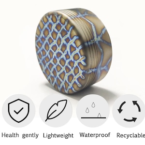 May include: A cylindrical object with a textured surface featuring a blue and gold pattern. The object has a series of parallel lines around its side. The image also includes icons with the words: Health gently, Lightweight, Waterproof, and Recyclable.
